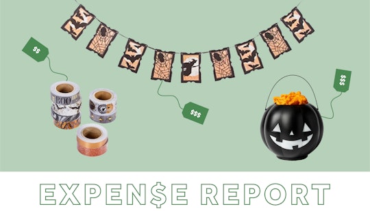 Halloween hanging decorations, a black carved pumpkin and candles with "expense report" written belo...