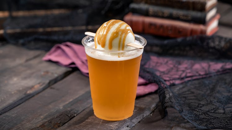 This Spiked Hard Apple Float is an Instagrammable Disney drink with apple sorbet and a caramel drizz...