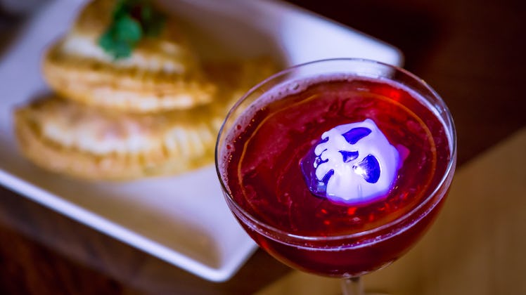 This Poison Apple-Tini is an Instagrammable Disney drink that's available at Disneyland for Hallowee...
