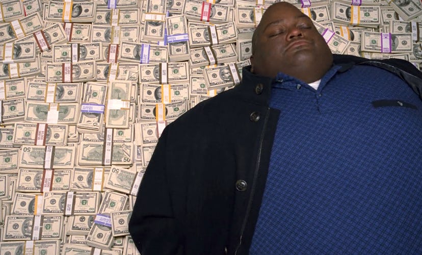 Lavell Crawford in his iconic Breaking Bad pose — on top of a stack of cash. 