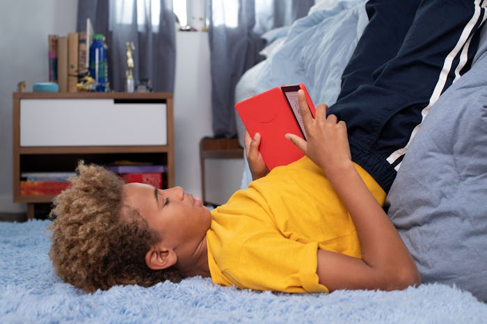 teen tween boy reading book in his room, amazon kindle kids