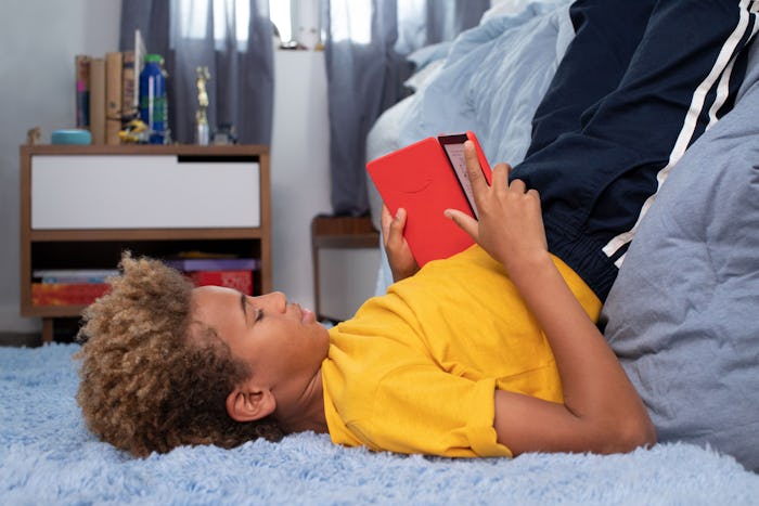 teen tween boy reading book in his room, amazon kindle kids 