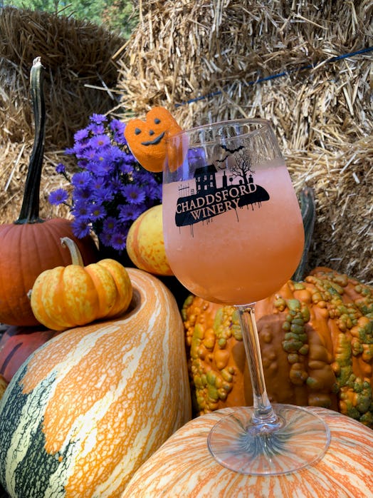 A wine glass filled with a drink sits in a pumpkin display at Chaddsford Winery's Adult Trick-or-Tre...