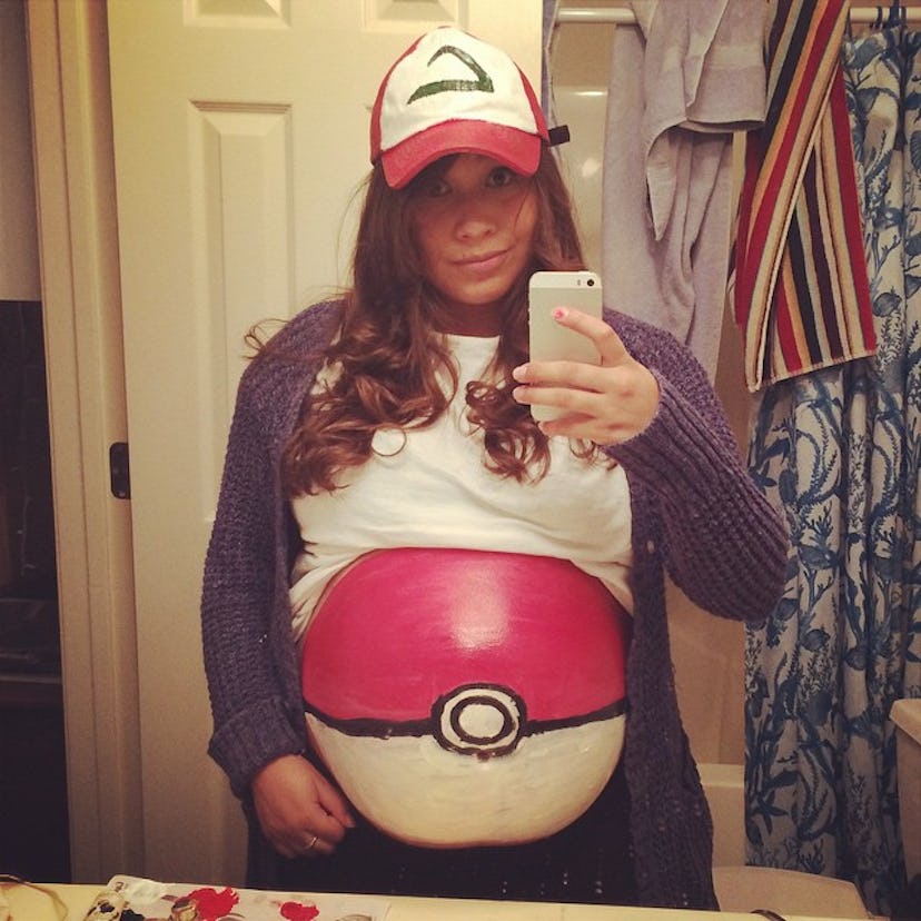 A pregnant woman dressed as Ash Ketchum and her belly is Poké Ball.