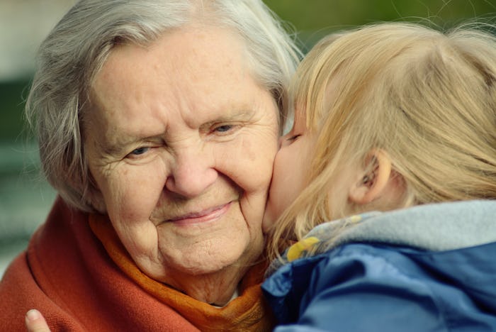 grandchild kisses her grandmother