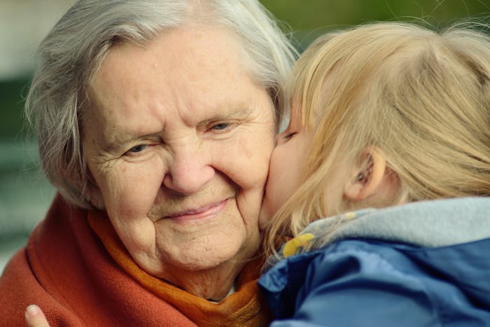 grandchild kisses her grandmother