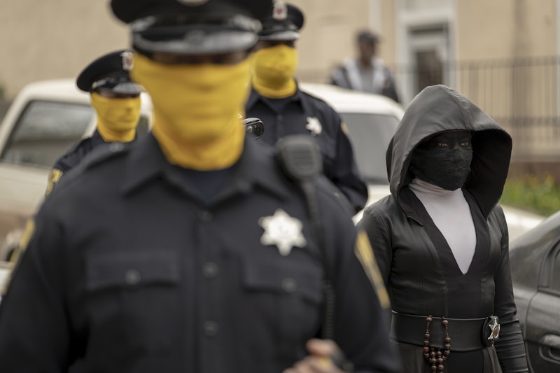 Masked Tulsa police officers and Regina King as Angela Abar/Sister Night in HBO's Watchmen