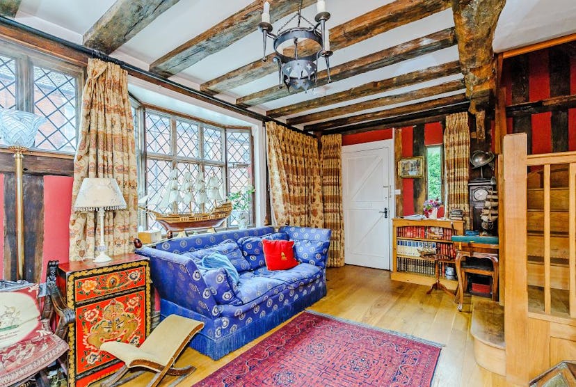 The bohemian reading room of The De Vere House features a blue couch, perfect for Ravenclaws who lov...