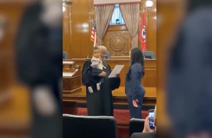 Judge holds lawyer's baby while he swears her in