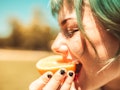Girl eating fruit to signify changing taste of vagina.