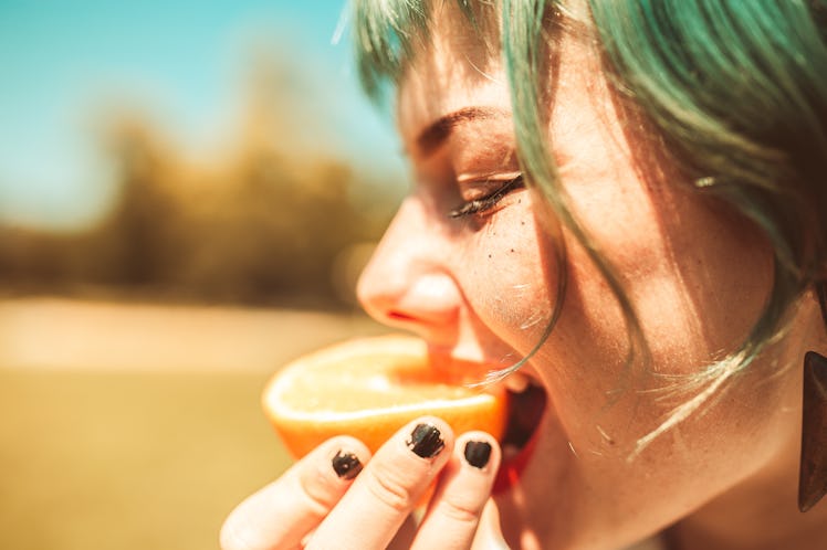 Girl eating fruit to signify changing taste of vagina.