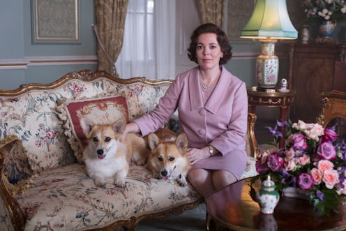 The Queen and her corgis sitting on a couch on The Crown