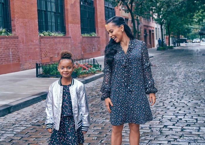 A mom and her daughter on a city street wearing Diane von Furstenberg X Rockets of Awesome