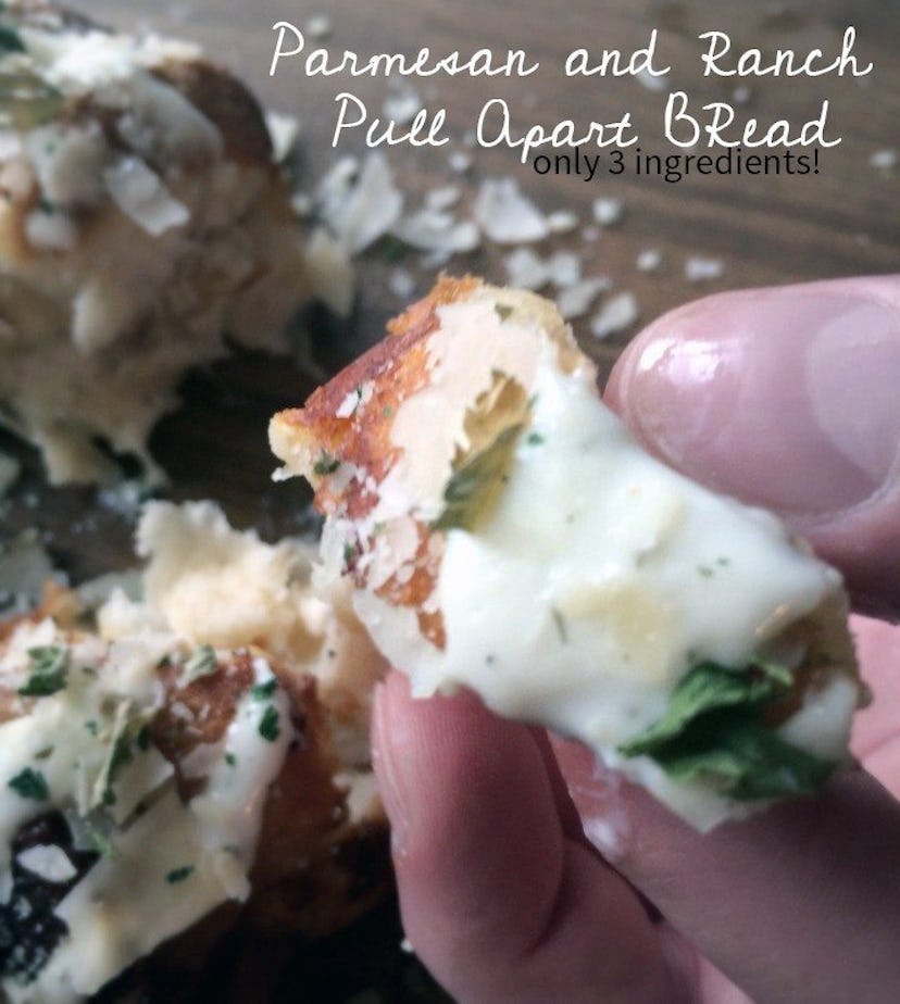 Easy Thanksgiving Dishes; Hand holding a piece of three-ingredient Parmesan ranch pull apart bread