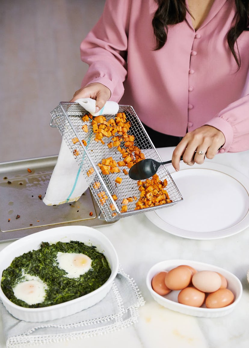 Easy Thanksgiving Dishes; Air Fryer Sweet Potatoes being scooped on to a platter