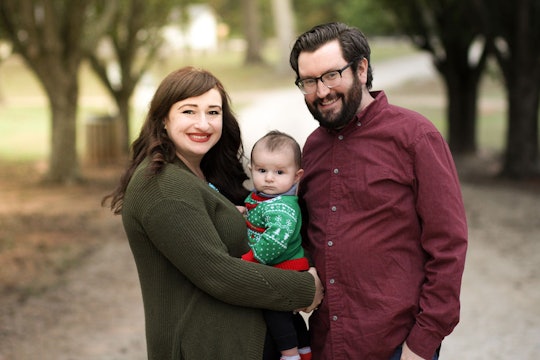 parents and a baby posed for a family portrait