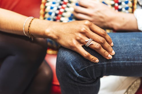 A person comforts a friend by placing their hand on their knee. During Trans Awareness Week, it's im...