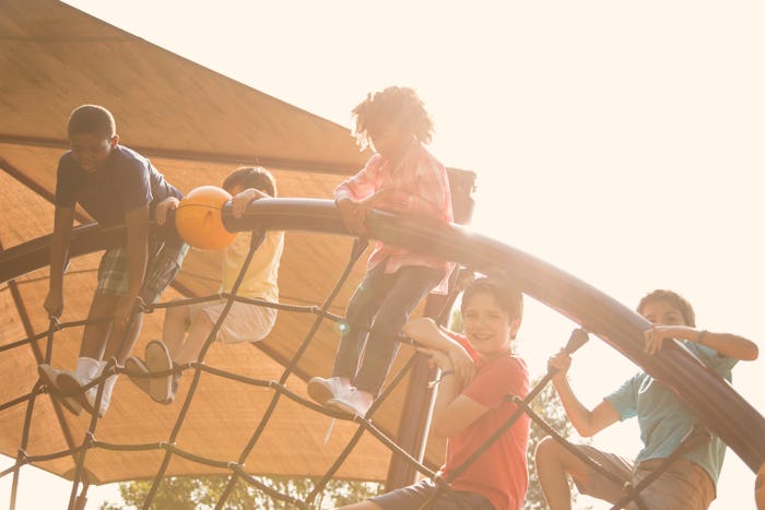 children climbing on a playground after school