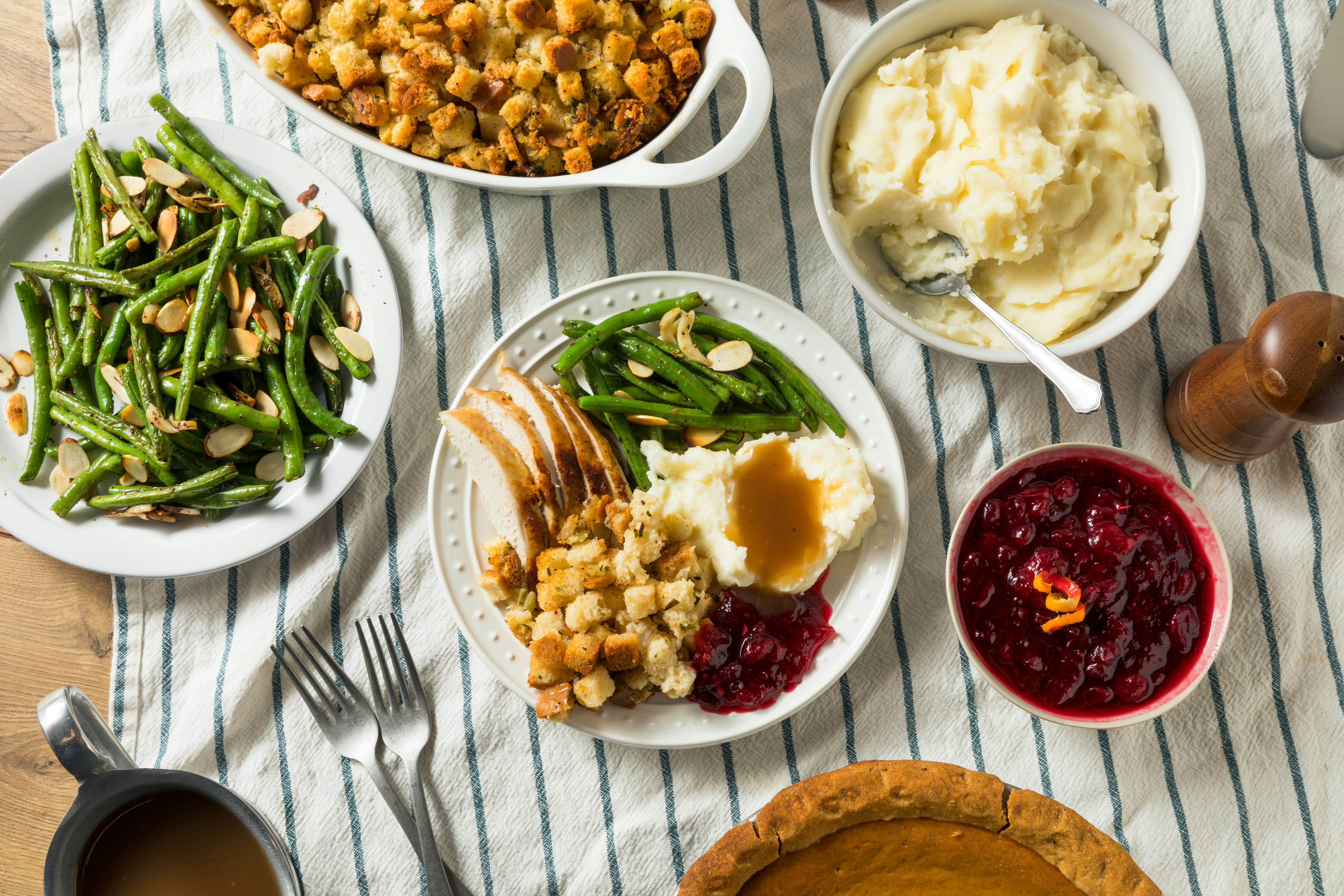 easy thanksgiving recipes; thanksgiving spread featuring cranberry sauce, mashed potatoes, and more