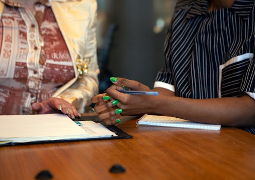 The hands of two colleagues in a meeting at work. Trans people often face a lot of obstacles to upda...
