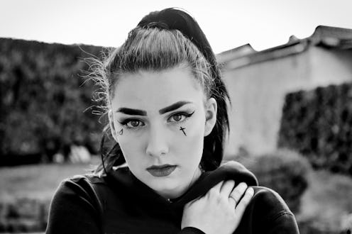 A girl with face tattoos