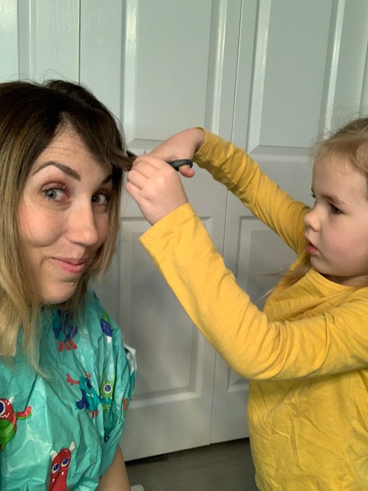 Mom receives haircut from toddler