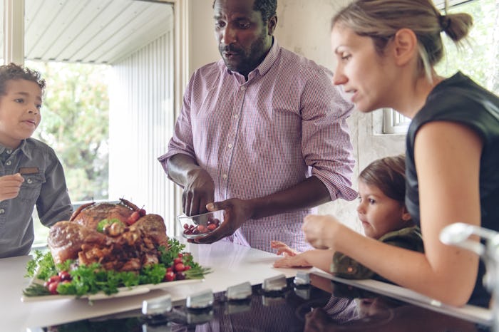 mom and dad serve turkey with their kids
