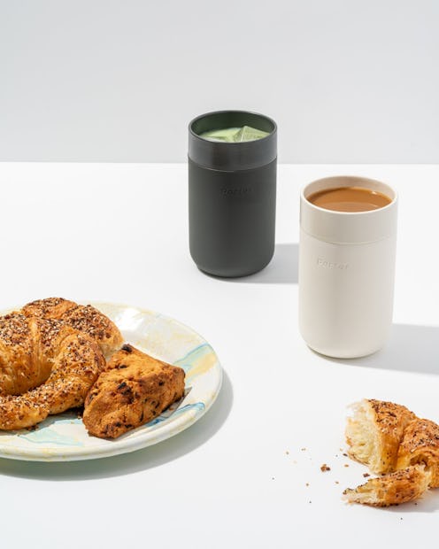 Croissants served on a plate and two coffee cups