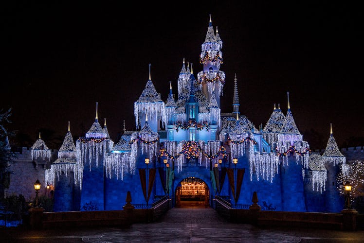 Sleeping Beauty's Castle at Disneyland lights up for the holidays with Christmas decor and icicle li...