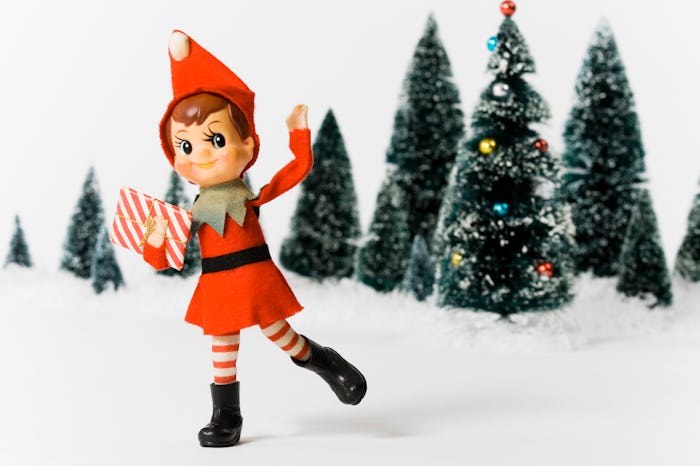 vintage elf doll throwing snow
