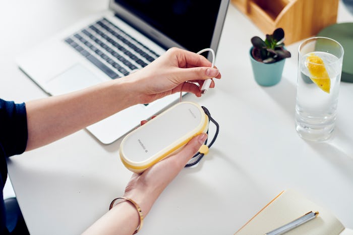 Medela's Freestyle Flex breast pump connecting to laptop to charge