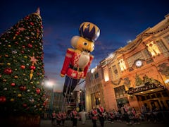 A nutcracker balloons flies over Universal Orlando during the holiday parade featuring Macy's.