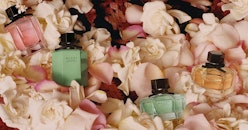 Gucci Flora Emerald Gardenia Limited Edition Next To Other Versions Of This Perfume Placed On Flower...