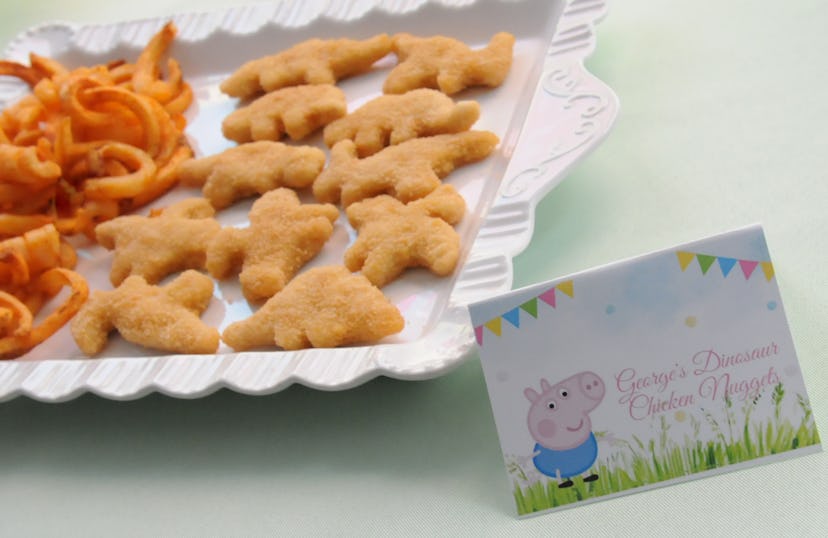 Tray of chicken nuggets with peppa Pig card.