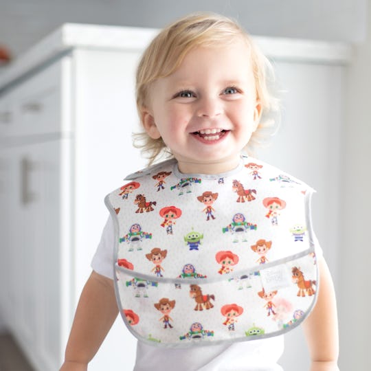 A baby boy wearing a Bumkins Disney bib