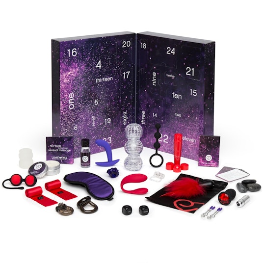 A midnight colored box style Advent calendar with an array of small sex toys placed before it. 