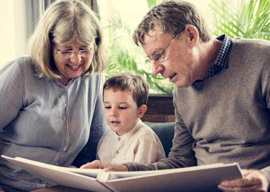 grandparents reading to kids on couch