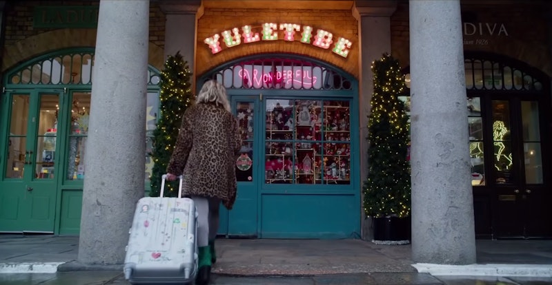 Emilia Clarke as Kate in front of the Yuletide Wonderful store in Last Christmas