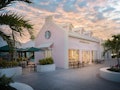 The exterior of Starbucks' Grand Turk store is millennial pink and surrounded by palm trees.
