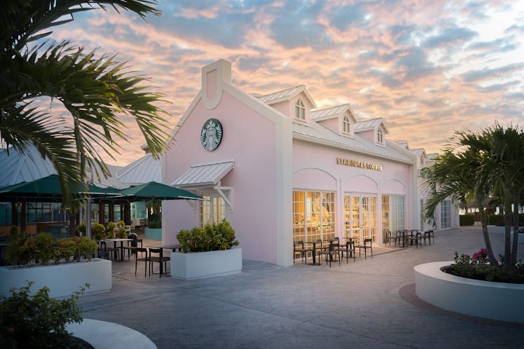 The exterior of Starbucks' Grand Turk store is millennial pink and surrounded by palm trees.