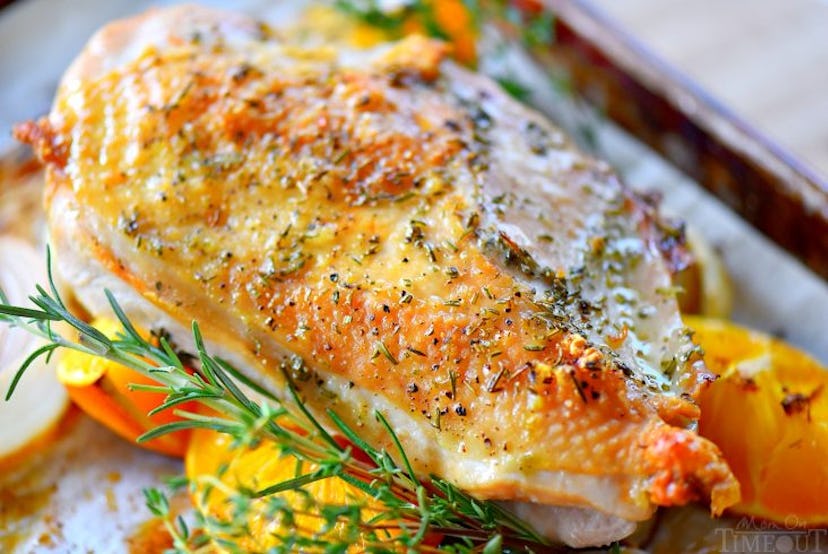 close up of sheet pan  roasted turkey on bed of rosemary and orange