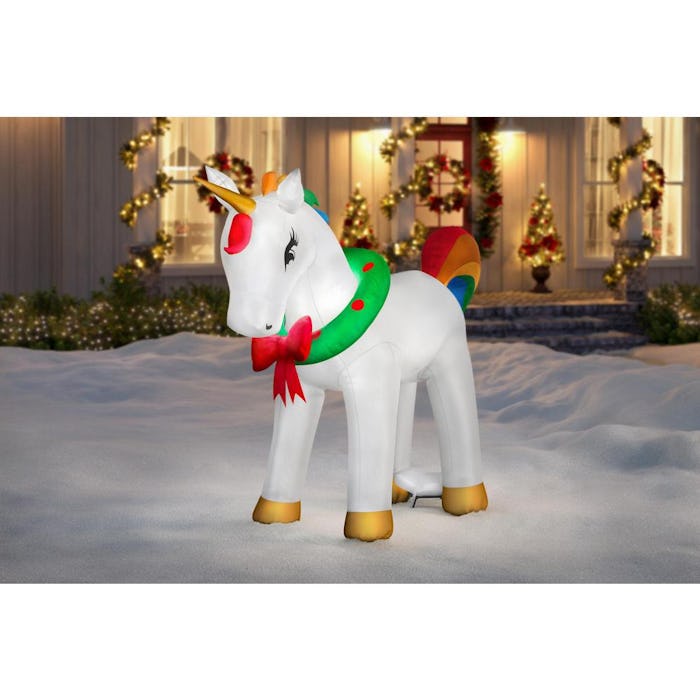 This unicorn Christmas inflatable features a wreath around its neck, rainbow mane and tail, and a me...