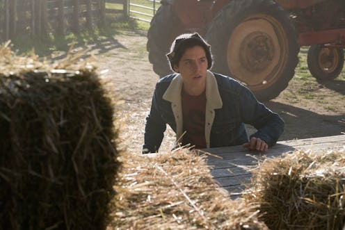 Jughead hiding behind hay bales on Riverdale