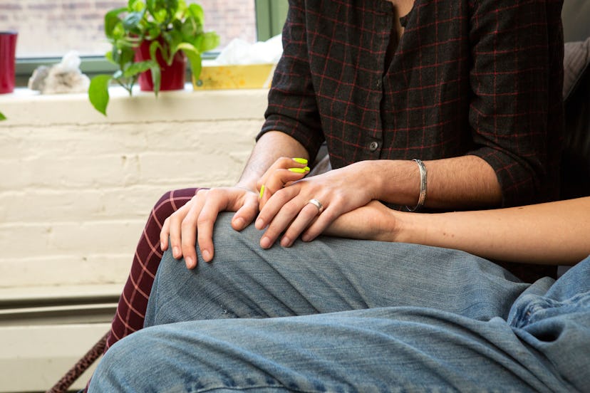 A couple holding hands on a couch. Getting effective treatment for depression may help you be able t...
