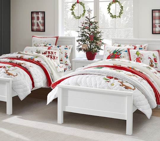 Two twin beds bedecked in white quilts with Grinch appliques