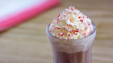 A glass of a warm peppermint chocolate float is offered at Disneyland's holiday celebration. 