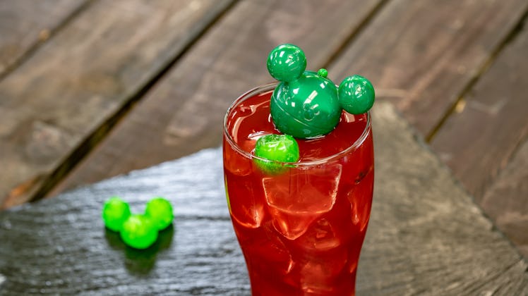 The red Navidad Punch with a green Mickey-shaped ice cube is offered at Disneyland's holiday celebra...