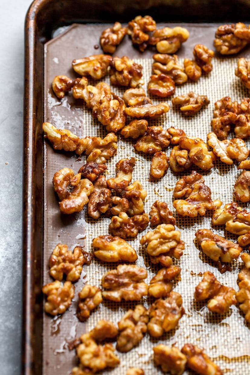 Thanksgiving sheet pan desserts, candied walnuts scattered across a baking sheet