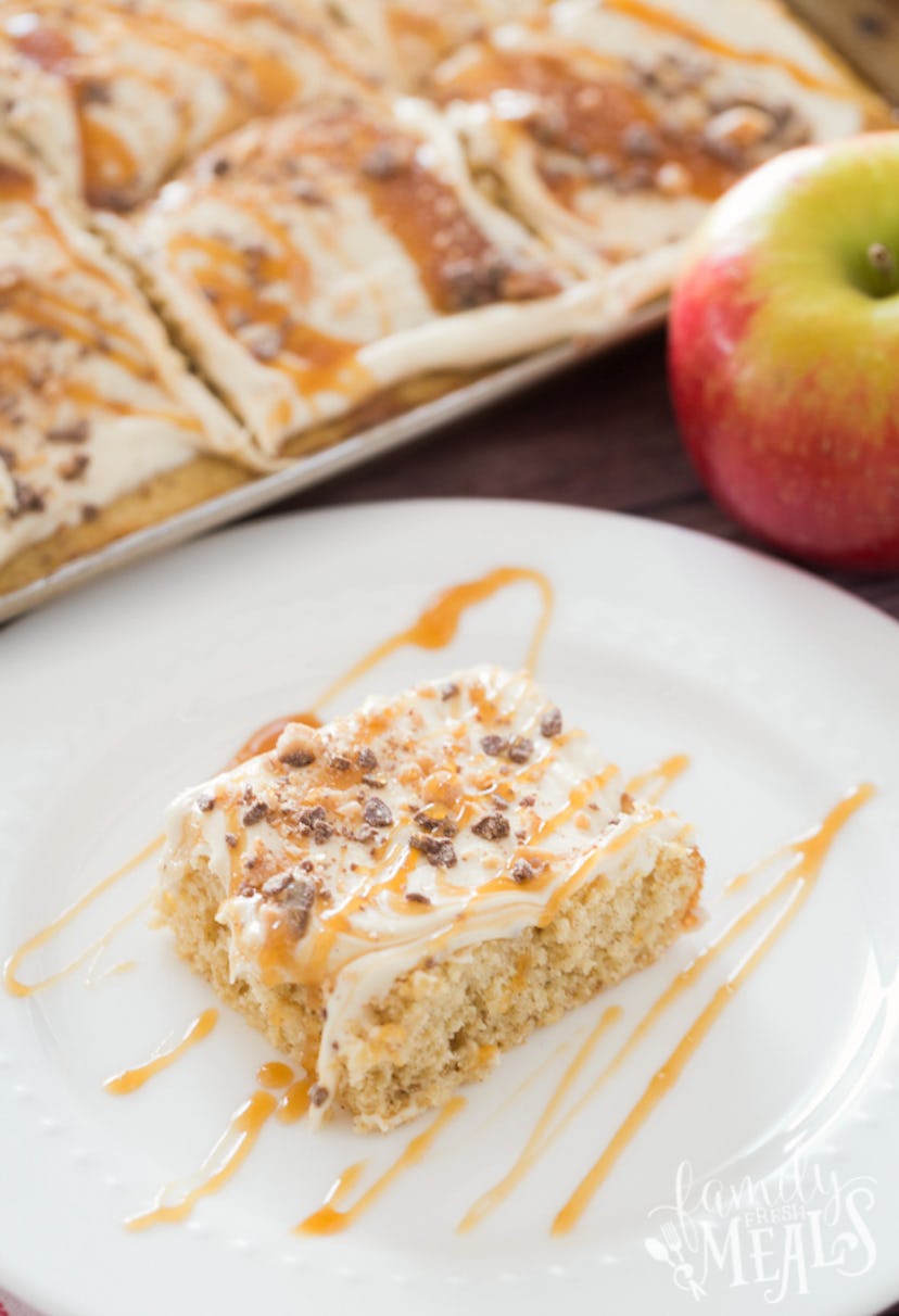 Thanksgiving sheet pan desserts, a cut square of caramel apple sheet cake on a white plate with cara...