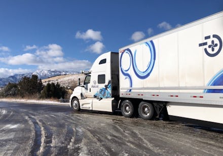 An autonomous semi truck driving through sleet.